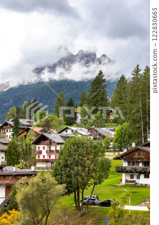 Italian Dolomite Alps mountains and houses, Italy 122830665