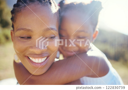 Happy black mother and playful daughter having fun together in the sun. Carefree woman carrying excited girl for a back ride while bonding outside. Single mom enjoying quality family time with kid Happy black mother and playful daughter having fun together in the sun. Carefree woman carrying excited girl for a back ride while bonding outside. Single mom enjoying quality family time with kid 122830739