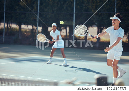 Fitness, fun and a couple playing tennis on a court outside and happy in the sun. Health, exercise and partners in a weekend game together. Action, teamwork and a man and woman in a match in sunshine Fitness, fun and a couple playing tennis on a court outside and happy in the sun. Health, exercise and partners in a weekend game together. Action, teamwork and a man and woman in a match in sunshine 122830785