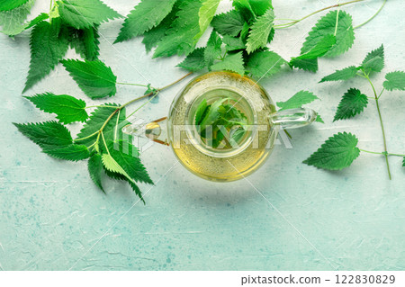 Nettle tea. Medicinal herbal tea with Urtica leaves. Fresh wild herb 122830829