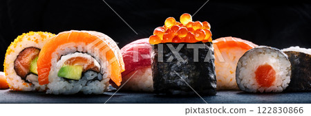 Sushi rolls panorama on a black background. Ikura maki roll Sushi rolls panorama on a black background. Ikura maki roll 122830866