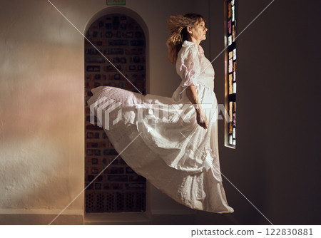Ghost of senior woman, looking at stained glass and floating over floor of building or cathedral. Elderly soul, phantom or dead spirit staring at beautiful window at a chapel or church after funeral 122830881