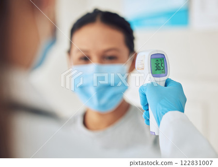 Covid doctor thermometer, patient safety check and corona virus risk in hospital, clinic and medical surgery. Hands of healthcare worker consulting wellness temperature, service test and fever laser Covid doctor thermometer, patient safety check and corona virus risk in hospital, clinic and medical surgery. Hands of healthcare worker consulting wellness temperature, service test and fever laser 122831007