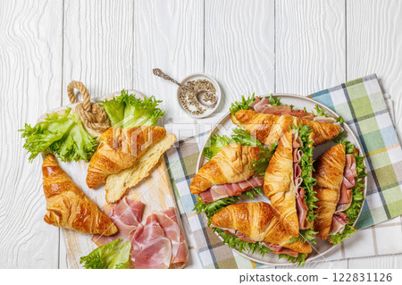 croissant sandwiches with ham and lettuce on plate croissant sandwiches with ham and lettuce on plate 122831126