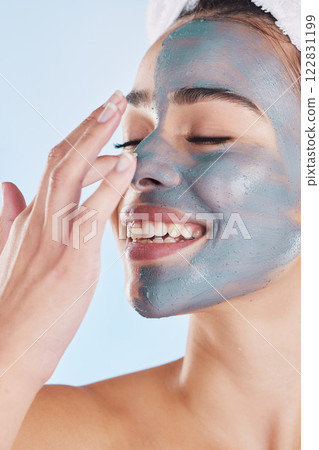 Charcoal face mask for beauty skincare, natural product for healthy skin and clean cosmetic wellness for body against blue mockup studio background. Happy, smile and healthcare on woman model Charcoal face mask for beauty skincare, natural product for healthy skin and clean cosmetic wellness for body against blue mockup studio background. Happy, smile and healthcare on woman model 122831199
