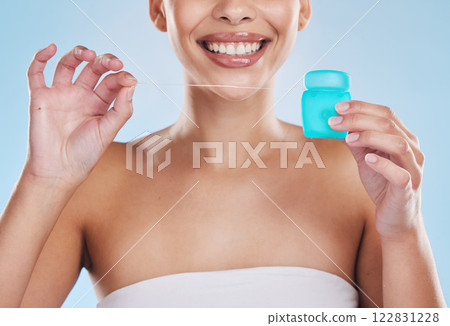 Oral, dentist and flossing product of woman with clean, white teeth in a studio blue background mockup. Young model mouth with perfect smile and gum health for hygiene, healthcare and dental mock up 122831228