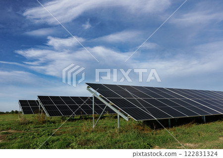 Solar panels providing clean energy under a cloudy sky Solar panels providing clean energy under a cloudy sky 122831324