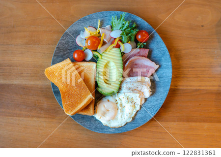 A nutritious morning plate of avocado, toast and salad chicken 122831361