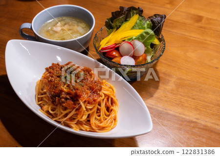 Western-style dinner of Bolognese pasta and colorful vegetable salad Western-style dinner of Bolognese pasta and colorful vegetable salad 122831386