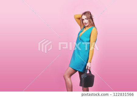 Beautiful woman wearing nice clothes, handbag posing on pink background. Fashion spring photo Beautiful woman wearing nice clothes, handbag posing on pink background. Fashion spring photo 122831566