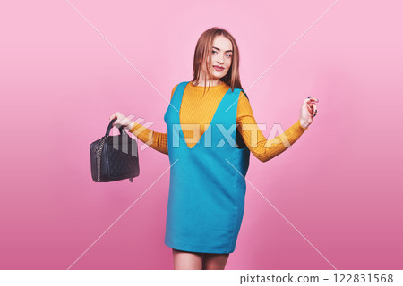 Beautiful woman wearing nice clothes, handbag posing on pink background. Fashion spring photo Beautiful woman wearing nice clothes, handbag posing on pink background. Fashion spring photo 122831568