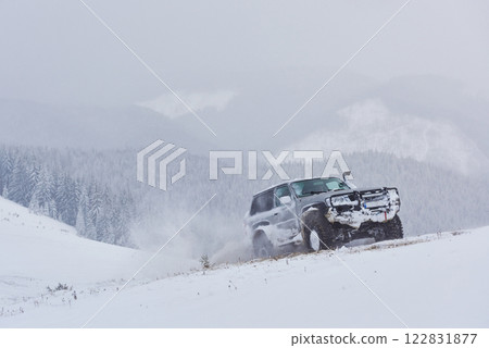 SUV rides on a winter mountians driving risk of snow and ice, drifting 122831877