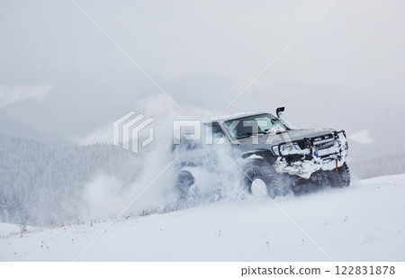 SUV rides on a winter mountians driving risk of snow and ice, drifting SUV rides on a winter mountians driving risk of snow and ice, drifting 122831878