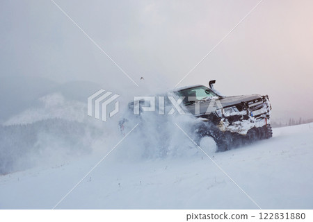 SUV rides on a winter mountians driving risk of snow and ice, drifting 122831880