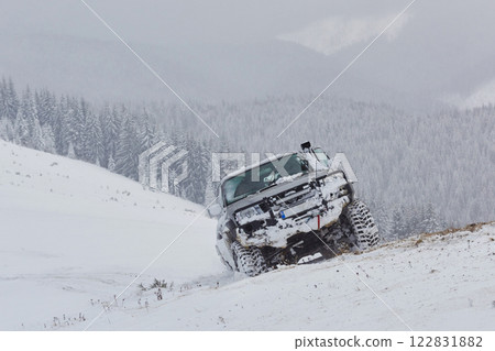 SUV rides on a winter mountians driving risk of snow and ice, drifting SUV rides on a winter mountians driving risk of snow and ice, drifting 122831882