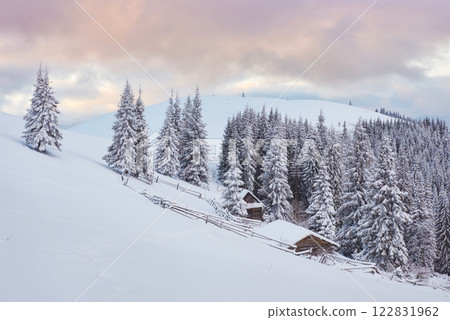 Majestic sunset at small village on a snowy hill under Ukrainian. Villages in the mountains in winter. Beautiful winter landscape. Carpathians, Ukraine, Europe Majestic sunset at small village on a snowy hill under Ukrainian. Villages in the mountains in winter. Beautiful winter landscape. Carpathians, Ukraine, Europe 122831962