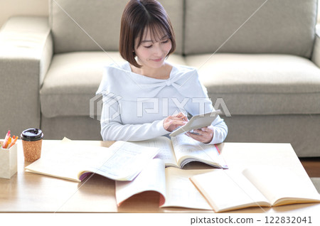 A young woman studying alone in the living room A young woman studying alone in the living room 122832041