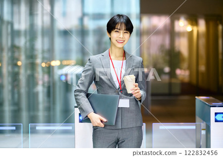 A businesswoman in a suit passing through a security gate. Photo courtesy of Sky Perfect Tokyo Media Center. A businesswoman in a suit passing through a security gate. Photo courtesy of Sky Perfect Tokyo Media Center. 122832456