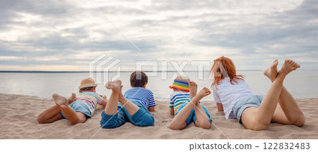 Group of for people lying on the sunny sand beach. Group of for people lying on the sunny sand beach. 122832483