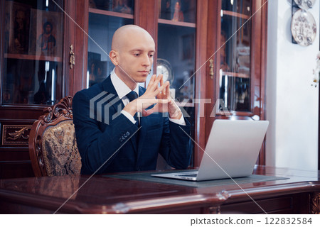 Confident handsome businessman sitting in luxury interior 122832584