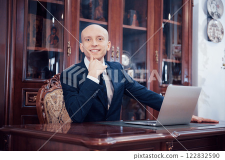 Confident handsome businessman sitting in luxury interior 122832590