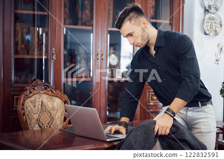 Confident handsome businessman sitting in luxury interior 122832591