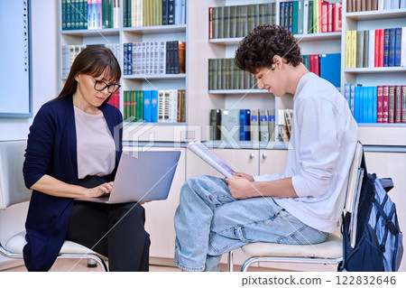 Guy college student talking studying with female teacher Guy college student talking studying with female teacher 122832646