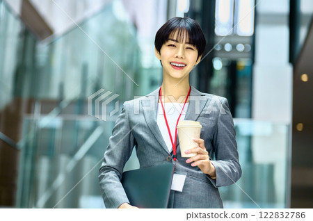 A businesswoman in a suit with a laptop working in an office. Photo courtesy of Sky Perfect Tokyo Media Center. A businesswoman in a suit with a laptop working in an office. Photo courtesy of Sky Perfect Tokyo Media Center. 122832786