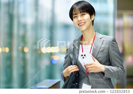A businesswoman in a suit with a laptop computer going to work. Photo courtesy of Sky Perfect Tokyo Media Center. 122832853