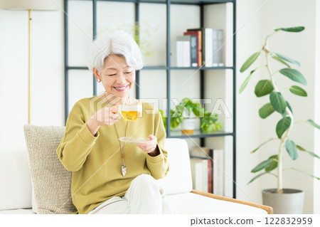 Senior woman drinking herbal tea in the living room 122832959
