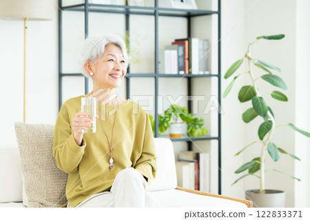 Senior woman drinking mineral water Senior woman drinking mineral water 122833371