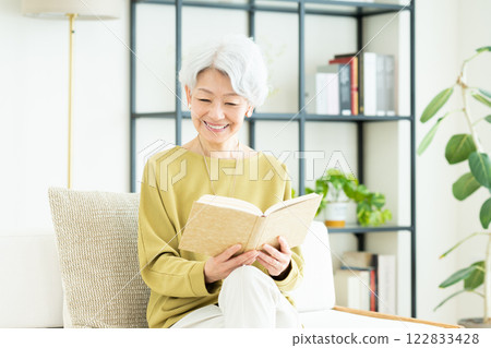 Senior woman reading in the living room Senior woman reading in the living room 122833428