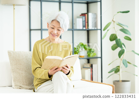 Senior woman reading in the living room Senior woman reading in the living room 122833431