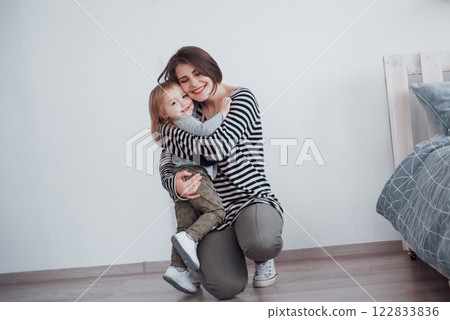 Happy loving family. Mother and her daughter child girl playing and hugging Happy loving family. Mother and her daughter child girl playing and hugging 122833836
