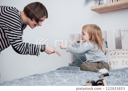 Happy loving family. Mother and her daughter child girl playing and hugging 122833853