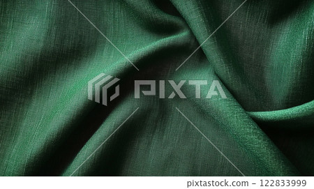 Green fabric with a pattern of waves. The fabric is very smooth and shiny. The color of the fabric is very bright and it looks very fresh 122833999
