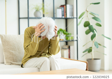 Senior woman worried in the living room 122834025