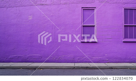 Purple wall with a window on it. The wall is empty and the window is the only thing on it 122834070