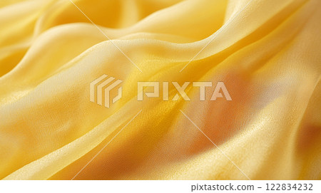Yellow fabric with a shiny texture. The fabric is smooth and has a slight sheen to it Yellow fabric with a shiny texture. The fabric is smooth and has a slight sheen to it 122834232