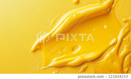 Yellow paint stain on a yellow background. The paint is thick and has a glossy texture. Concept of creativity and artistic expression Yellow paint stain on a yellow background. The paint is thick and has a glossy texture. Concept of creativity and artistic expression 122834233