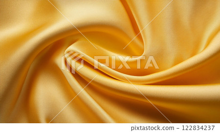 Gold fabric with a wavy pattern. The fabric is very shiny and looks very luxurious. The fabric is very soft and smooth to the touch Gold fabric with a wavy pattern. The fabric is very shiny and looks very luxurious. The fabric is very soft and smooth to the touch 122834237