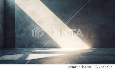 Large room with a wall that is covered in a greyish color. The room is empty and has a very plain and simple appearance 122834307