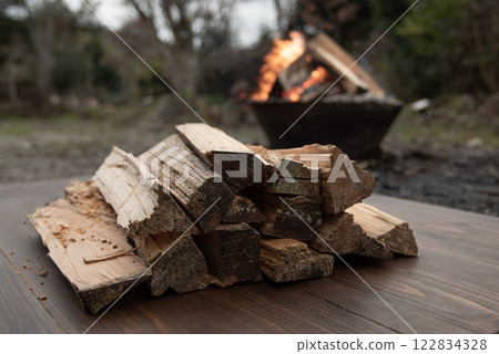 Background of firewood piled on table and bonfire Background of firewood piled on table and bonfire 122834328