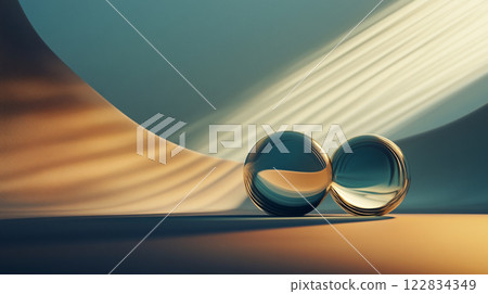 Two large, clear spheres are sitting on a sandy surface, with the sun shining on them. The scene is serene and peaceful, with the sun casting a warm glow on the spheres and the sand 122834349