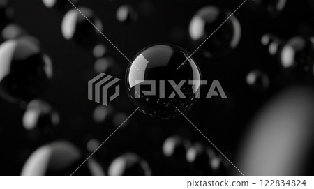 Close up of black spheres with a shiny surface. The spheres are all different sizes and are scattered throughout the image. Scene is one of mystery and intrigue 122834824