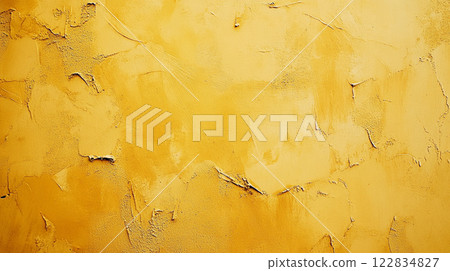 Yellow wall with a lot of paint peeling off. The wall has a lot of texture and he is unfinished 122834827