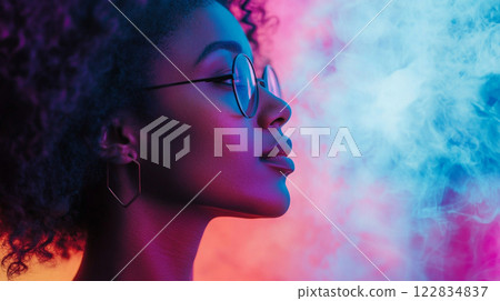 Woman with curly hair and glasses is looking at a colorful background with smoke in the air. Concept of mystery and intrigue, as the woman's gaze seems to be focused on something beyond the smoke 122834837