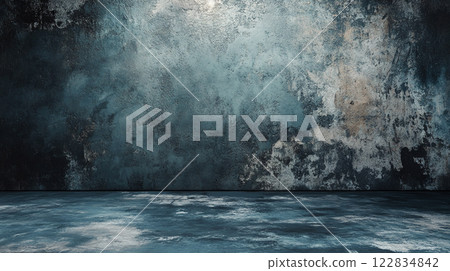 Large, empty room with a blue wall and a grey floor. The room is bare and empty, with no furniture or decorations. The blue wall and grey floor create a cold, sterile atmosphere 122834842