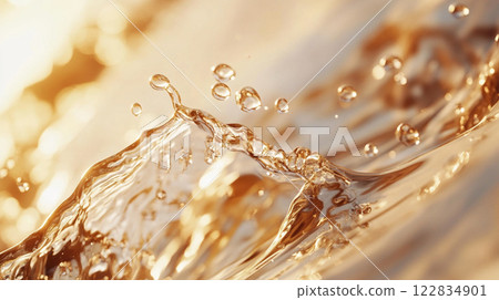 Splash of water with many droplets on a surface. The water is golden in color. Concept of movement and energy Splash of water with many droplets on a surface. The water is golden in color. Concept of movement and energy 122834901