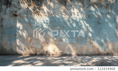 Wall with a blue background and a shadow on it. The shadow is on the wall and it is very dark 122834908